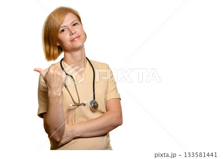 A female doctor, a medical worker, points her thumb behind her. A female doctor, a medical worker, points her thumb behind her. 133581441