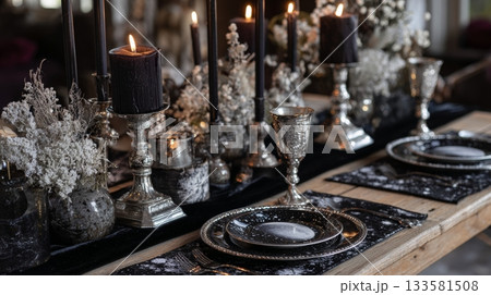 Antique silver goblets and celestial-themed plates on a dark velvet table runner, creating a moody Gothic Christmas ambiance Antique silver goblets and celestial-themed plates on a dark velvet table runner, creating a moody Gothic Christmas ambiance 133581508