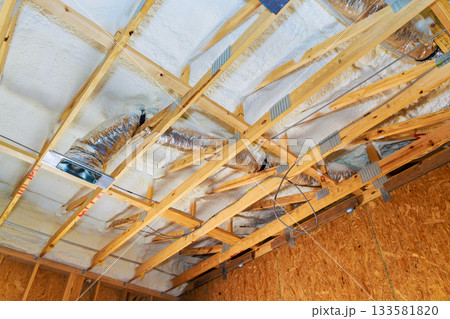 Wooden beams framework duct work of ceiling in new home under construction. Wooden beams framework duct work of ceiling in new home under construction. 133581820