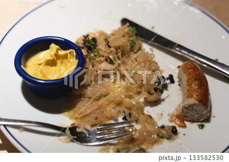 Sausage With Sauerkraut and Mustard on White Plate Sausage With Sauerkraut and Mustard on White Plate 133582530