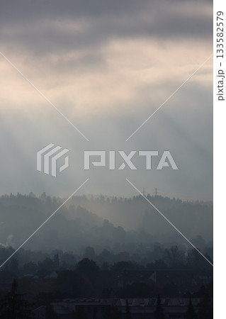 The sky is cloudy and the sun is shining through the clouds The sky is cloudy and the sun is shining through the clouds 133582579