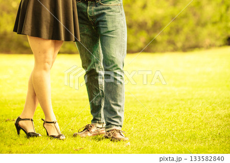 Couple standing in grass. Couple standing in grass. 133582840