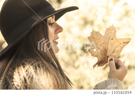 Young lady with leaf outdoor 133582854