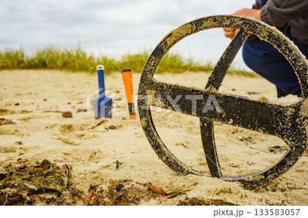 Man with metal detector on sea beach Man with metal detector on sea beach 133583057