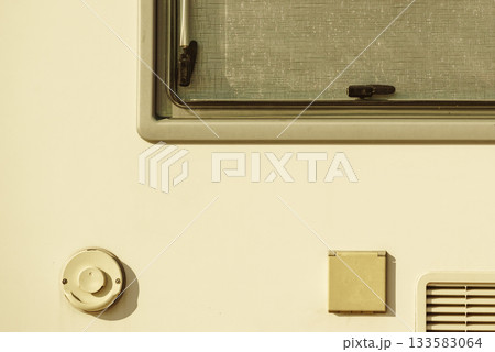Details of camper, window with cover blind 133583064