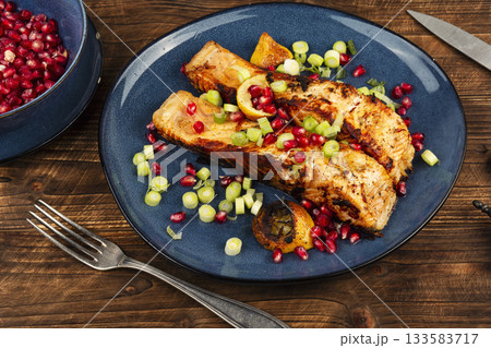 Appetizing fried fish steak on wooden surface. Appetizing fried fish steak on wooden surface. 133583717