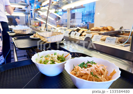 Vegetable salads on counter of public dining 133584480