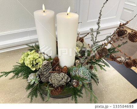 Christmas Advent wreath with two lit white candles on table Christmas Advent wreath with two lit white candles on table 133584693