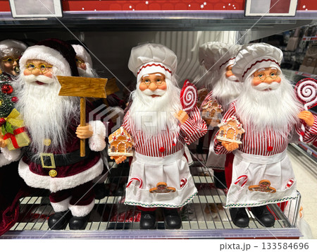 Santa figurines with gifts and candy on a store shelf 133584696