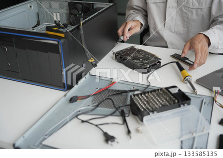 Closeup hand of computer hardware technician dissemble and fixing computer PC. Closeup hand of computer hardware technician dissemble and fixing computer PC. 133585135