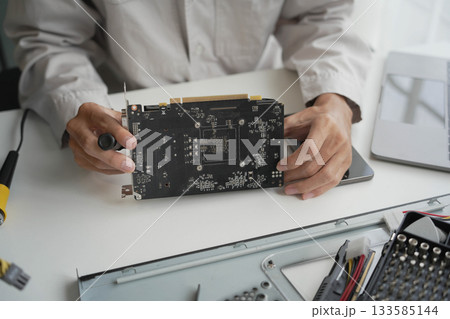 Closeup hand of computer hardware technician dissemble and fixing computer PC. Closeup hand of computer hardware technician dissemble and fixing computer PC. 133585144