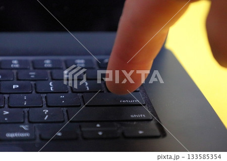 Finger Pressing Laptop Return Key 133585354