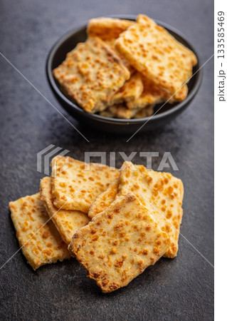 Crunchy salted crackers on black table. 133585469