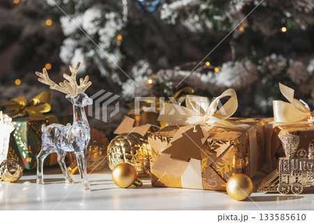 Crystal Reindeer with Gold Antlers and Christmas Gifts in Festive Interior 133585610