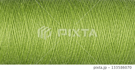 macro texture of a skein of green sewing thread 133586070