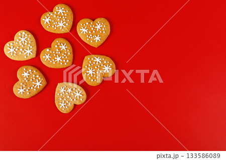 beautiful hand-baked cookies in the shape of a heart on a red background 133586089