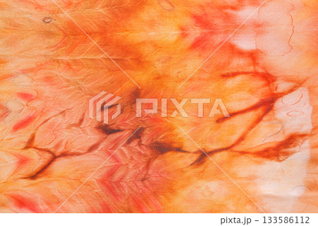 abstract pattern on silk fabric texture in yellow and brown tones abstract pattern on silk fabric texture in yellow and brown tones 133586112