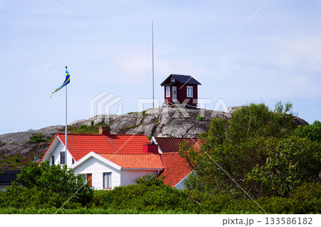 Traditional wooden houses near marina on peaceful car-free Vrango island with seaside village in Gothenburg archipelago, Sweden Traditional wooden houses near marina on peaceful car-free Vrango island with seaside village in Gothenburg archipelago, Sweden 133586182