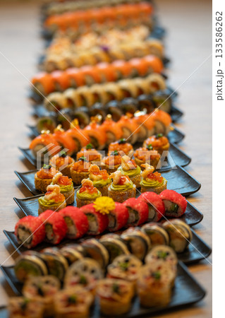 A vibrant array of many different types of gourmet sushi and maki rolls 133586262