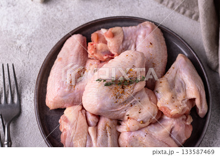 Raw chicken wings on black background. Raw chicken wings on black background. 133587469
