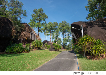 Scenery view of the rocks garden in Wat Ahong Silawat temple in Bueng Kan province of Thailand. Many beautiful natural big rocks spread in temple area as rock garden. 133590138