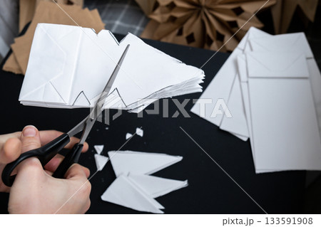 Master class of making craft paper snowflakes for conscientious Christmas decor. Sustainable celebration minimal responsible DIY holiday project. Step by step Master class of making craft paper snowflakes for conscientious Christmas decor. Sustainable celebration minimal responsible DIY holiday project. Step by step 133591908
