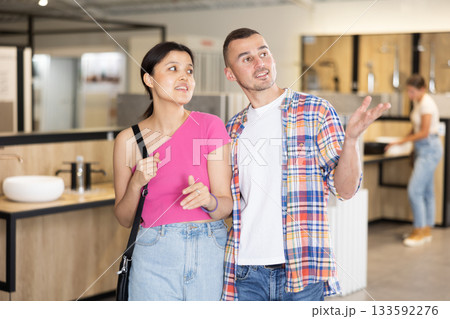 Husband and wife choosing bathroom accessories together at hardware store 133592276