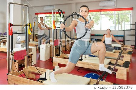 Young woman doing exercises with pilates ring Young woman doing exercises with pilates ring 133592379