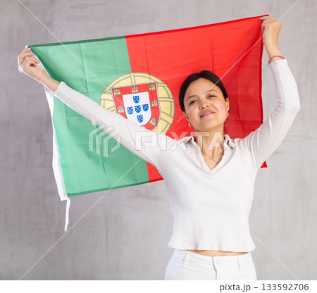 Young woman posing in studio with Portugal flag 133592706