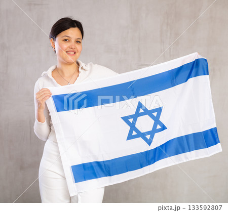 Young woman posing in studio with Israel flag 133592807