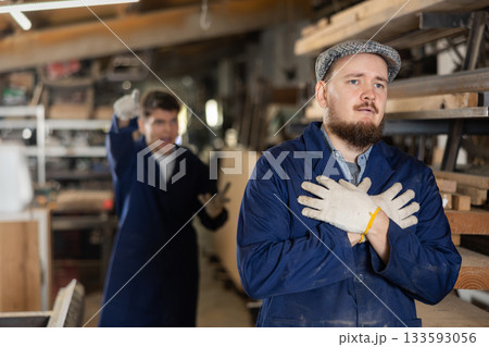 Young male carpenters quarreling in workshop Young male carpenters quarreling in workshop 133593056