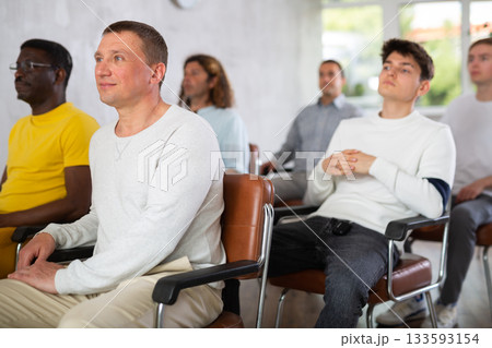 Group of men listening to lecture in auditorium attentively Group of men listening to lecture in auditorium attentively 133593154