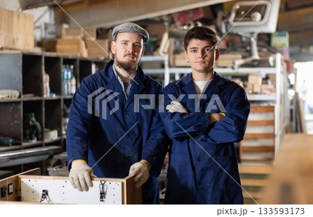 Young male carpenters posing in wood workshop 133593173