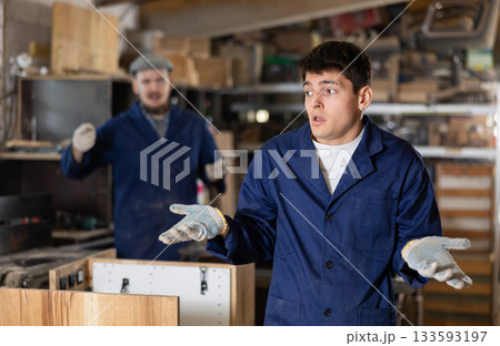 Disgruntled furniture factory owner yells at careless worker 133593197