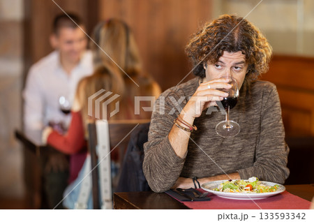 Adult man having dinner in restaurant Adult man having dinner in restaurant 133593342