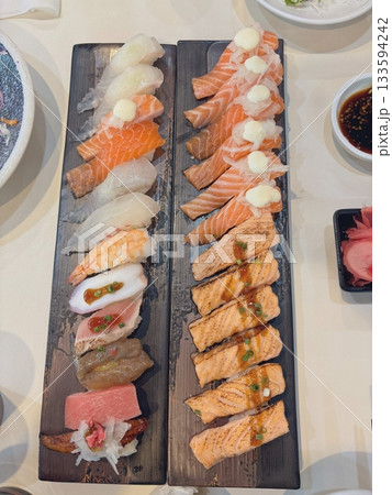 An assortment of fresh sushi, artfully arranged with a variety of toppings and vibrant colors. This traditional Japanese dish combines vinegared rice, seafood, and vegetables for an experience. An assortment of fresh sushi, artfully arranged with a variety of toppings and vibrant colors. This traditional Japanese dish combines vinegared rice, seafood, and vegetables for an experience. 133594242