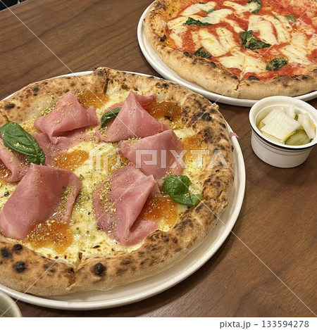 A delicious pizza with a golden crust, melted cheese, and savory toppings. Perfect for food-related designs, menus, or Italian-themed projects, capturing the essence of a classic comfort dish. 133594278