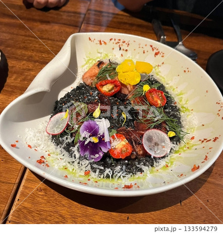 Creamy risotto cooked to perfection with rich, buttery texture and savory flavors. A classic Italian dish perfect for gourmet menus, food blogs, and elegant dining promotions. 133594279