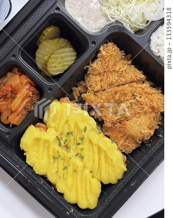 Crispy tonkatsu cutlet stuffed with melted cheese, creating a savory blend of crunch and creaminess. A comforting and satisfying dish with a rich, golden finish. 133594318