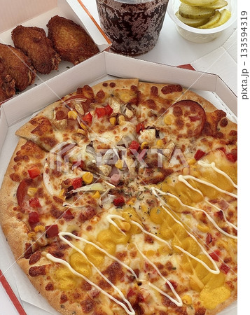 A delicious pizza with a golden crust, melted cheese, and savory toppings. Perfect for food-related designs, menus, or Italian-themed projects, capturing the essence of a classic comfort dish. 133594319