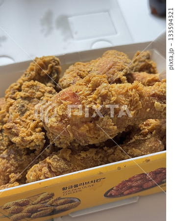 Crispy Korean fried chicken, perfectly glazed with a sweet and spicy sauce. Ideal for food photography and menus, showcasing the irresistible crunch and flavor of this beloved dish. 133594321