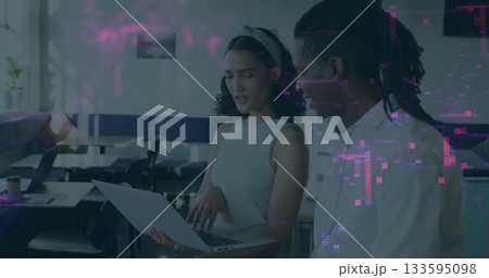 Pointing woman holding laptop and guiding colleague in button-up shirt through data in office Pointing woman holding laptop and guiding colleague in button-up shirt through data in office 133595098