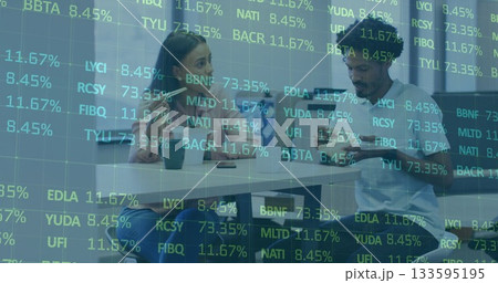 Reviewing digital stock data, two colleagues using smartphone and tablet in meeting room with mugs Reviewing digital stock data, two colleagues using smartphone and tablet in meeting room with mugs 133595195