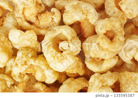 Closeup of pork snack or pork rinds, deep fried pork skin and blistered is traditional food in the north of Thailand. 133595387