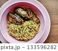 Instant noodles with spicy canned fish in a pink bowl, simple budget meal. 133596282