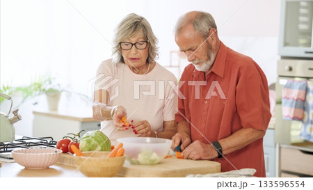 Senior couple preparing healthy meal together in kitchen 133596554
