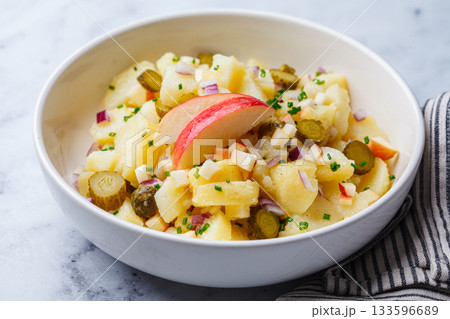 Traditional German potato salad with pickles, onions and apple. Traditional German potato salad with pickles, onions and apple. 133596689
