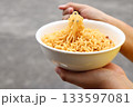 Spicy instant noodles bowl eating and hand 133597081