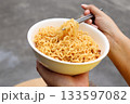 Spicy instant noodles bowl eating and hand 133597082