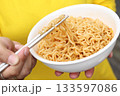 Spicy instant noodles bowl eating and hand 133597086